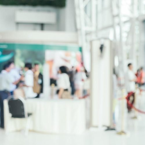 Blurred background : people shopping at market fair in sunny day, blur background with bokeh.